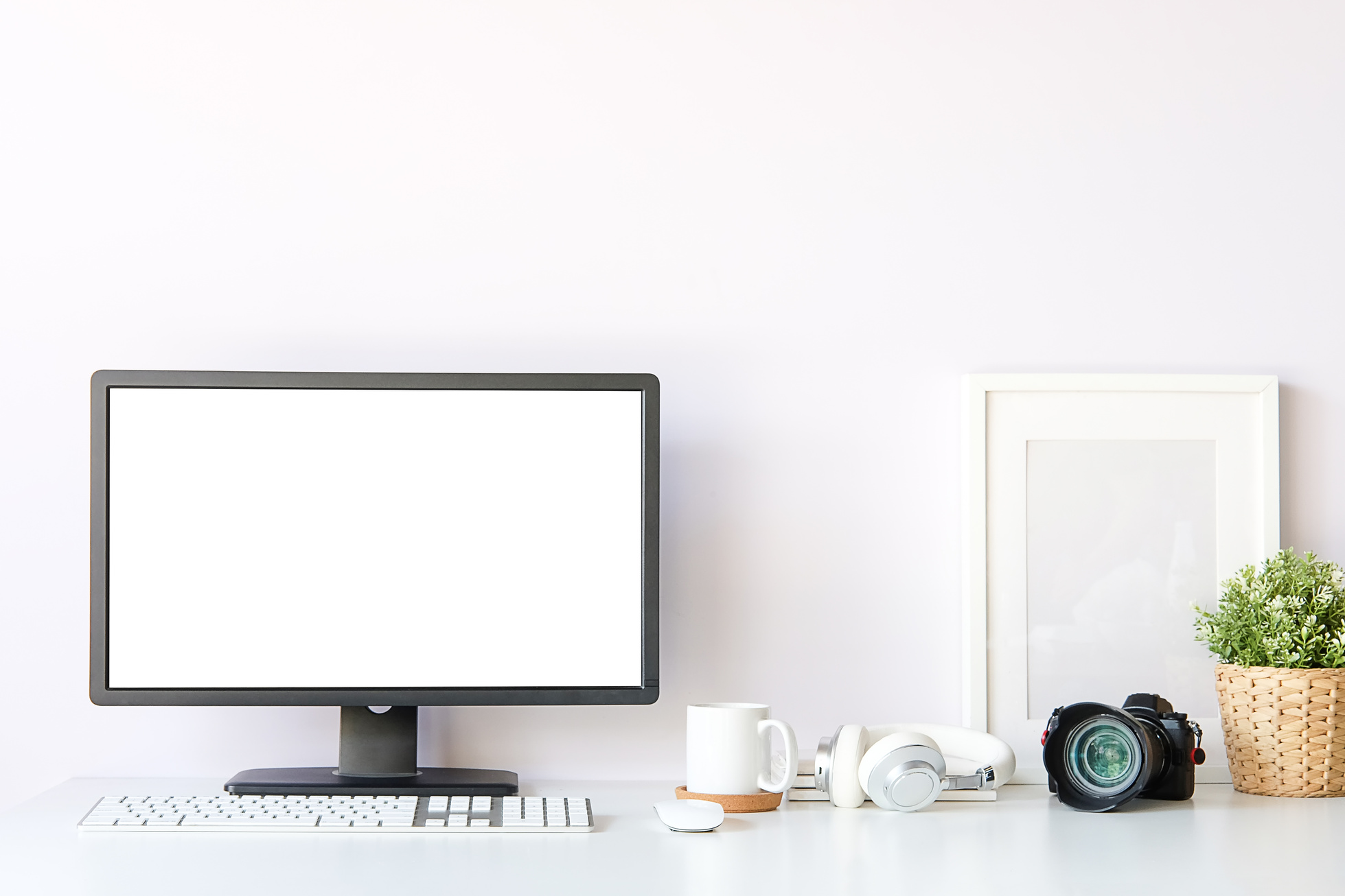 Composition of Computer, Frame, Cup, Headphones, Plant, and Camera
